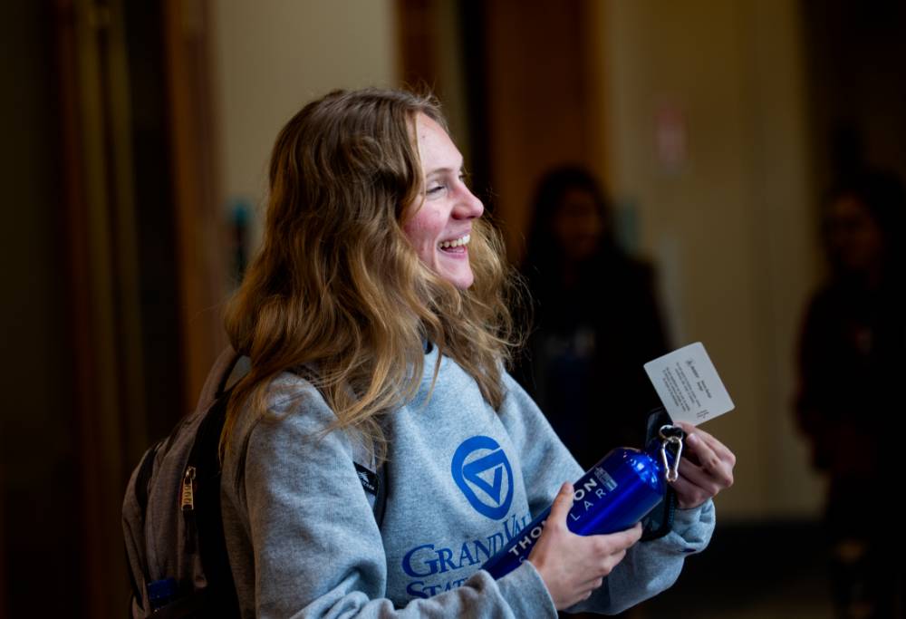 A Thompson Scholar holding on to a water bottle that she received.